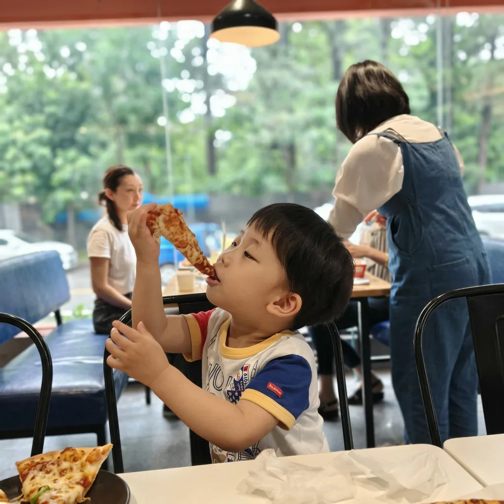 A young guest enjoying a slice at GOPIZZA